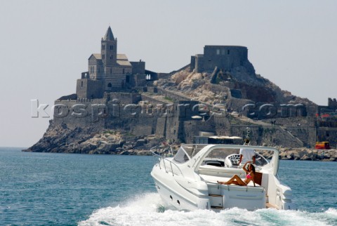 A glamorous model onboard a luxurious powerboat in the Mediterranean