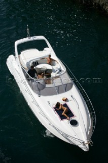 A glamorous model onboard a luxurious powerboat in the Mediterranean