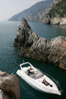 A glamorous model onboard a luxurious powerboat in the Mediterranean