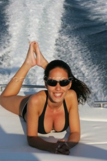 A glamorous model onboard a luxurious powerboat in the Mediterranean