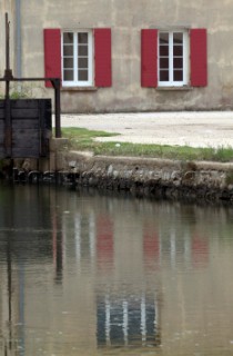 Colourful reflections in water of buildings and architecture in southern France