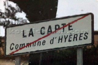 Colourful reflections in water of buildings, road sign and architecture in southern France