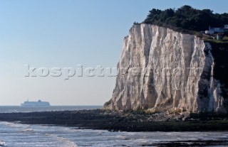 White cliffes of dover and ferry on its way to Calais