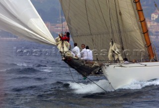 Crew on bowsprit of classic yacht