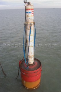 Construction of Windfarm on the Kentish flats in the Thames estuary off Whitstble Kent. Onboard the construction ship Resolution during the foundation process, where the Monopile is hammered in to the seabed with a hydraulic hammer and the transition piece lowered onto the monopile, picture shows monopile being craned into place ready for piling into seabed