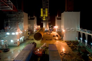 Construction of Windfarm on the Kentish flats in the Thames estuary off Whitstble Kent. Onboard the construction ship Resolution during the foundation process, where the Monopile is hammered in to the seabed with a hydraulic hammer and the transition piece lowered onto the monopile, picture shows monopile being craned into place ready for piling into seabed