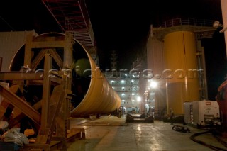 Construction of Windfarm on the Kentish flats in the Thames estuary off Whitstble Kent. Onboard the construction ship Resolution during the foundation process, where the Monopile is hammered in to the seabed with a hydraulic hammer and the transition piece lowered onto the monopile, picture shows monopile being craned into place ready for piling into seabed