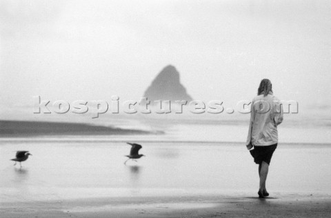 Girl walking on KeriKeri Beach Nr Aukland NZ   