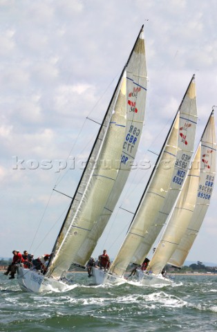 Three Mumm 30 racing yachts in line