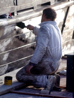 Man painting hull of boat