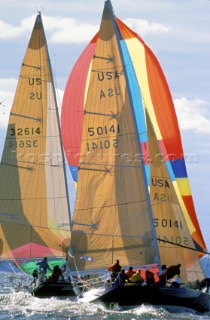 Two yachts race down wind in light winds