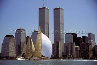 Two yachts race infront of the dramatic skyscape of New York City