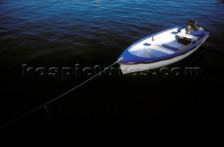 Small blue boat moored in harbour