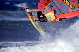 Close up of windsurfer jumping off wave