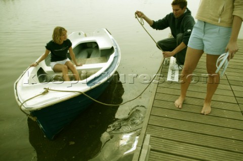 Casting off a small dinghy from a wooden dock