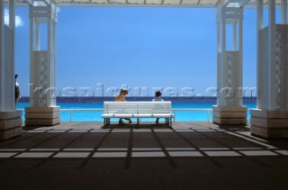 Ladies on white bench under sun shade - Promenade des Anglais, Nice, France