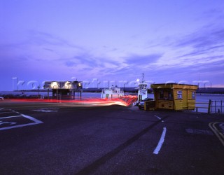 Light trails of traffic boarding chainlink ferry, Sandbanks, Poole harbour, Dorset