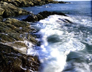 Waves breaking over rocks at Limebury Point, Salcombe Estuary, South Devon