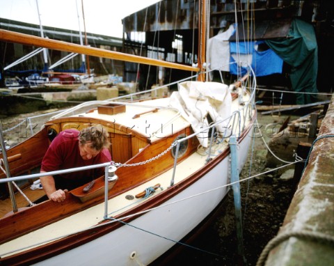 Man restoring classic wooden yacht at traditional boat builders Littlehampton Sussex