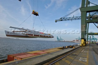 Crane lifting G Class catamaran Cayenne on to a container ship in the Port of Antwerp, Belgium