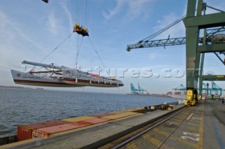 Crane lifting G Class catamaran Cayenne on to a container ship in the Port of Antwerp, Belgium