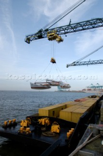 Crane lifting G Class catamaran Cayenne on to a container ship in the Port of Antwerp, Belgium