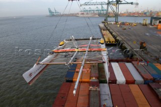 Crane lifting G Class catamaran Cayenne on to a container ship in the Port of Antwerp, Belgium