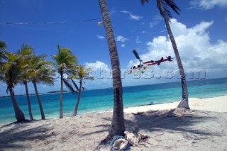 Helicopter flying low over sandy beach