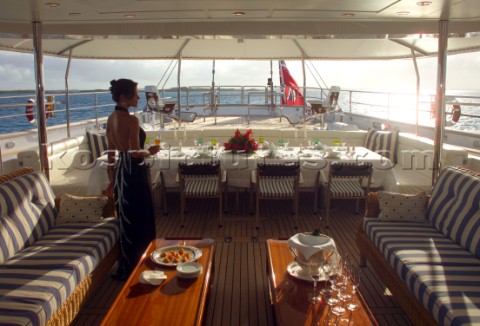Woman in evening dress on aft deck of superyacht