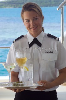 Superyacht stewardess with tray of cocktails