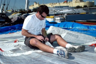 Crewman Herve Cunningham sewing mainsail Cheyenne