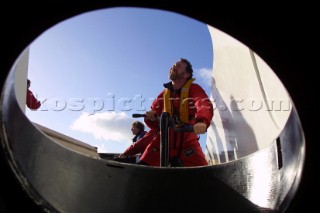 Maxi Catamaran Cheyenne on a 24 hour charge from Plymouth to Antwerp for loading on a ship to the Middle East. Crew grinding coffee grinder winches.