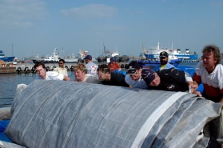 Crewmembers of Cheyenne rolling sail after repairs Dubai. From left Herve Cunningham, Tank, David Scully, Dingo Rollfe, Jim Close