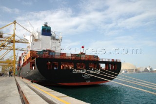 Commercial ship alongside a dock wall