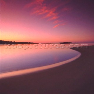 Wave lapping shore at sunset