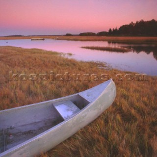 Canadian canoe on river bank