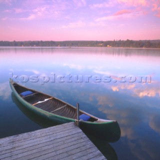 Canadian canoe moored to wooden jetty