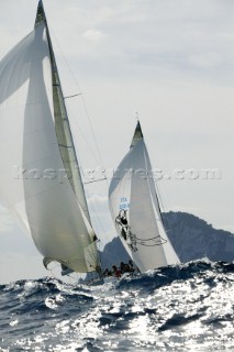 Swan yachts racing behind wave in rough seas