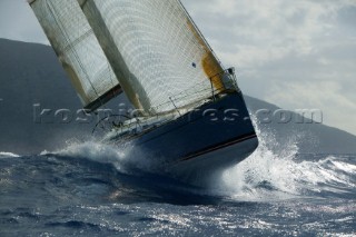 Bow of yacht crashing through wave in choppy seas