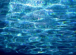 Shimmering reflections of surface of swimming pool