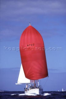 Oyster cruising yacht under red spinnaker