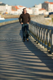 Male model walking along prommenade in casual wear