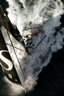 Vendee Globe Open 60 yacht Hugo Boss skippered by Alex Thomson crashing through rough seas in strong winds