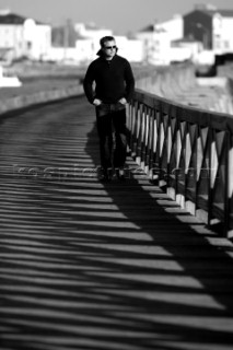 Male model walking along prommenade in casual wear