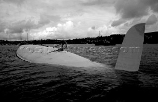 The Maxi yacht Drum owned by Simon Le Bon of Duran Duran lies upturned and capsized without its keel in Falmouth Harbour after the accident of the Fast race in 1985