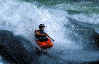 Canoeist paddling down rapids on the Zambezi River, Zambia