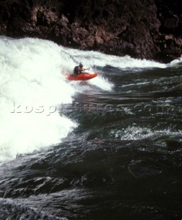 Canoeist paddling through big rapids on the Zambezi River, Zambia