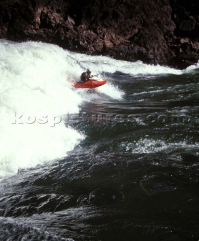 Canoeist paddling through big rapids on the Zambezi River Zambia