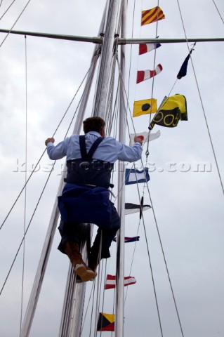 Man being hoisted up the mast of Gipsy Moth IV after her relaunch in June 2005