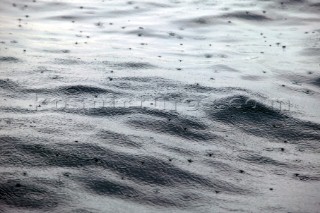 Rain drops on calm sea